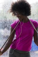 portrait of young afro american woman in gym while listening music photo