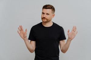 Young handsome male in casual t shirt saying no or rejecting proposition photo