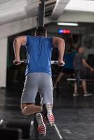 man doing exercises parallel bars photo