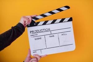 movie clapper on yellow background photo