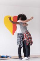 couple with painted heart on wall photo