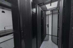 Data Center With Multiple Rows of Fully Operational Server Racks. Modern Telecommunications, Cloud Computing, Artificial Intelligence, Database, Supercomputer Technology Concept. photo