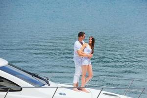 young couple on yacht photo