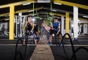 pareja de deportes haciendo ejercicio de fitness cruzado de cuerdas de batalla foto