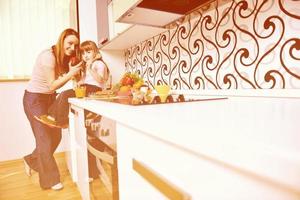 happy daughter and mom in kitchen photo