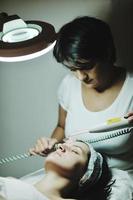 woman with facial mask in cosmetic studio photo