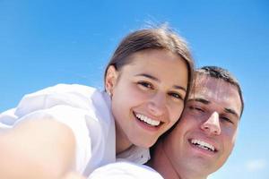 happy couple have fun on the beach photo