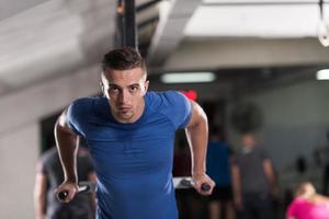 man doing exercises parallel bars photo