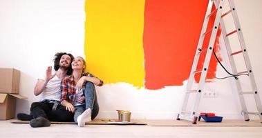 Happy young couple relaxing after painting photo