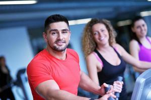 Group of people running on treadmills photo