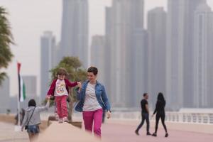 mother and cute little girl on the promenade photo