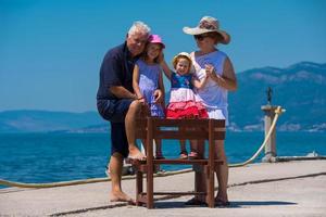 portrait of grandparents and granddaughters by the sea photo