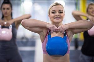 athletes doing exercises with kettlebells photo