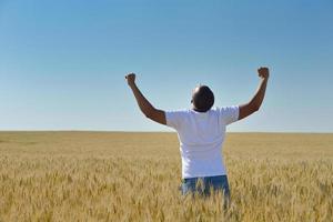 man in wheat field photo