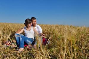 happy couple in wheat field photo