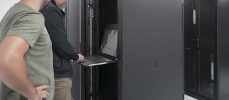 Technicians team updating hardware inspecting system performance in super computer server room or cryptocurrency mining farm. photo