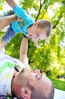 feliz padre e hijo se divierten en el parque foto