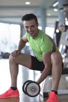 handsome man working out with dumbbells photo
