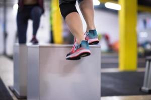 athletes working out  jumping on fit box photo