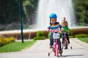 happy boy learning to ride his first bike photo