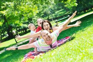 happy young couple with their children have fun at park photo