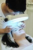 woman with facial mask in cosmetic studio photo