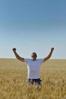 man in wheat field photo