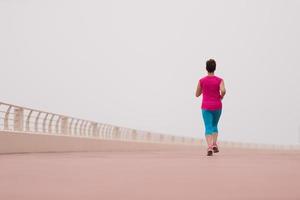 woman busy running on the promenade photo