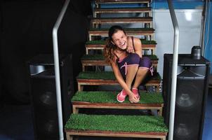 young woman smiling on green stairs photo