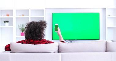 Young couple on the sofa watching television photo