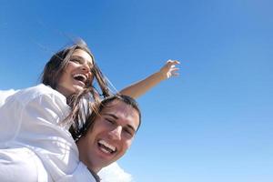 happy young couple have fun on beach photo