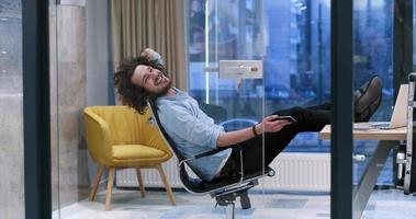 businessman sitting with legs on desk photo