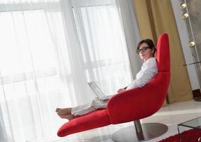 woman using a laptop computer at home photo