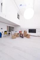 woman with many cardboard boxes sitting on floor photo