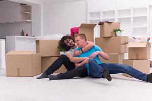 young  gay couple moving  in new house photo