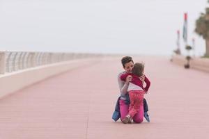 mother and cute little girl on the promenade by the sea photo