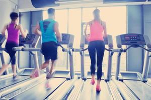 Group of people running on treadmills photo