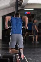 man doing exercises parallel bars photo