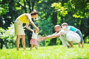 happy young couple with their children have fun at park photo