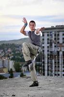 young man jumping in air outdoor at night ready to party photo