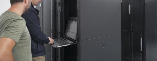 Technicians team updating hardware inspecting system performance in super computer server room or cryptocurrency mining farm. photo