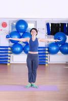 .happy young woman exercising in a gym photo