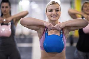 athletes doing exercises with kettlebells photo