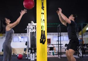 young athletes couple working out with medical ball photo