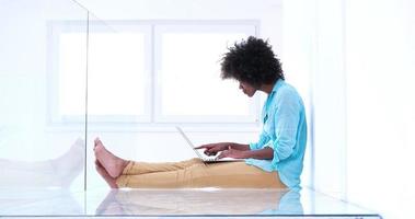 black women using laptop computer on the floor photo