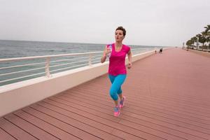 woman busy running on the promenade photo