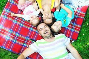 happy young couple with their children have fun at park photo