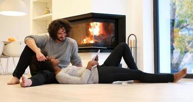 multiethnic couple using tablet computer on the floor photo