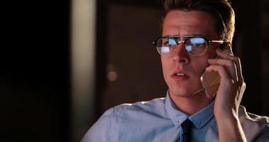 man using mobile phone in dark office photo