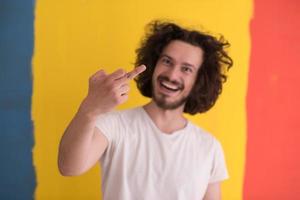 young man with funny hair over color background photo